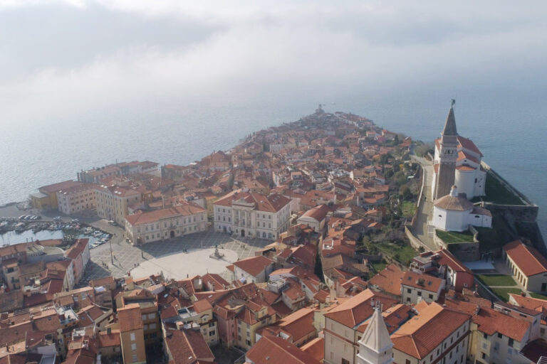 Aerial view of Piran with Saint George's Cathedral and Tartini Square